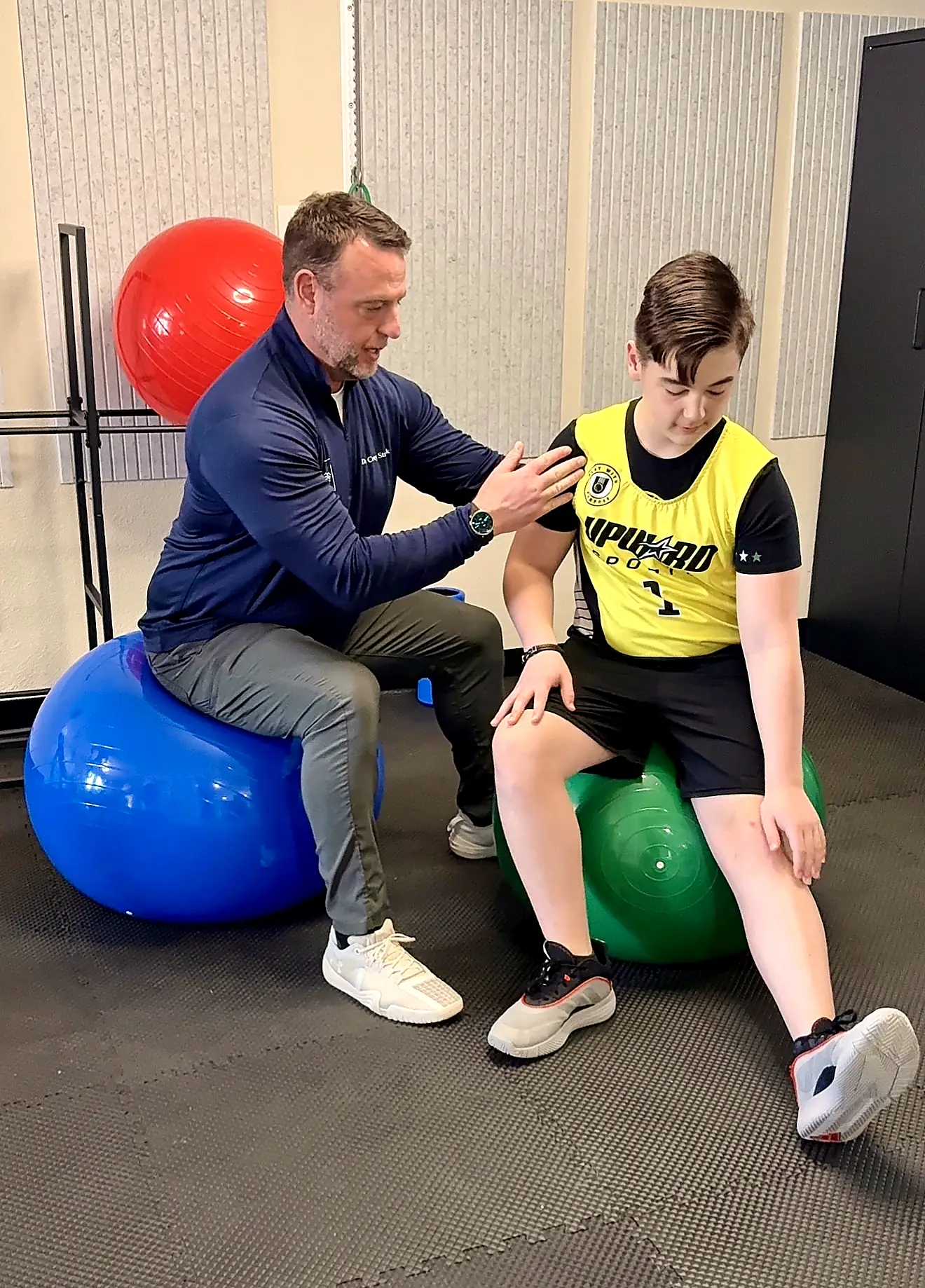 Dr. Corey Strunk performing a movement assessment with a young athlete at Firm Foundation Wellness Center in Keller, Texas
